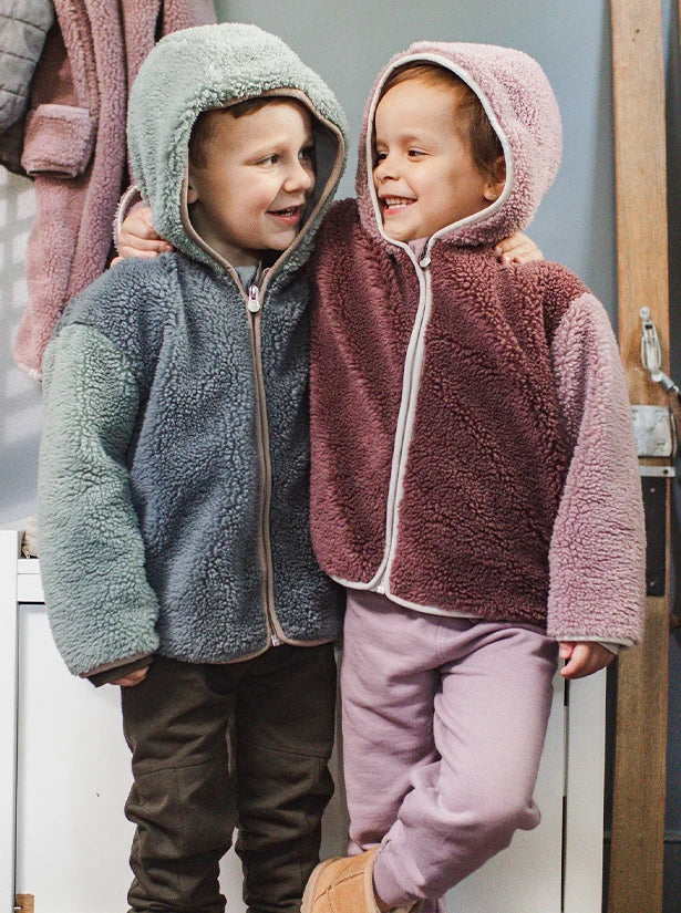 Children wearing cozy new fleece outfits