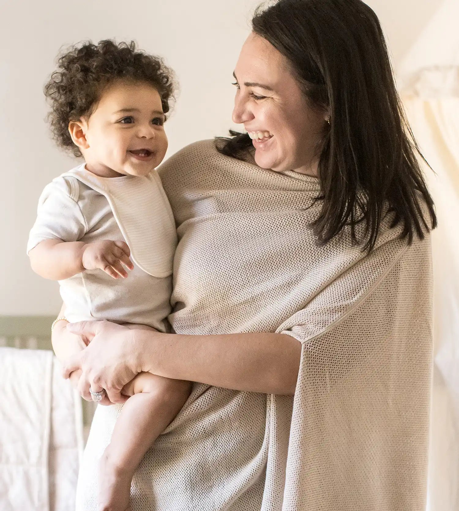 Parent holding a baby in soft organic cotton clothing